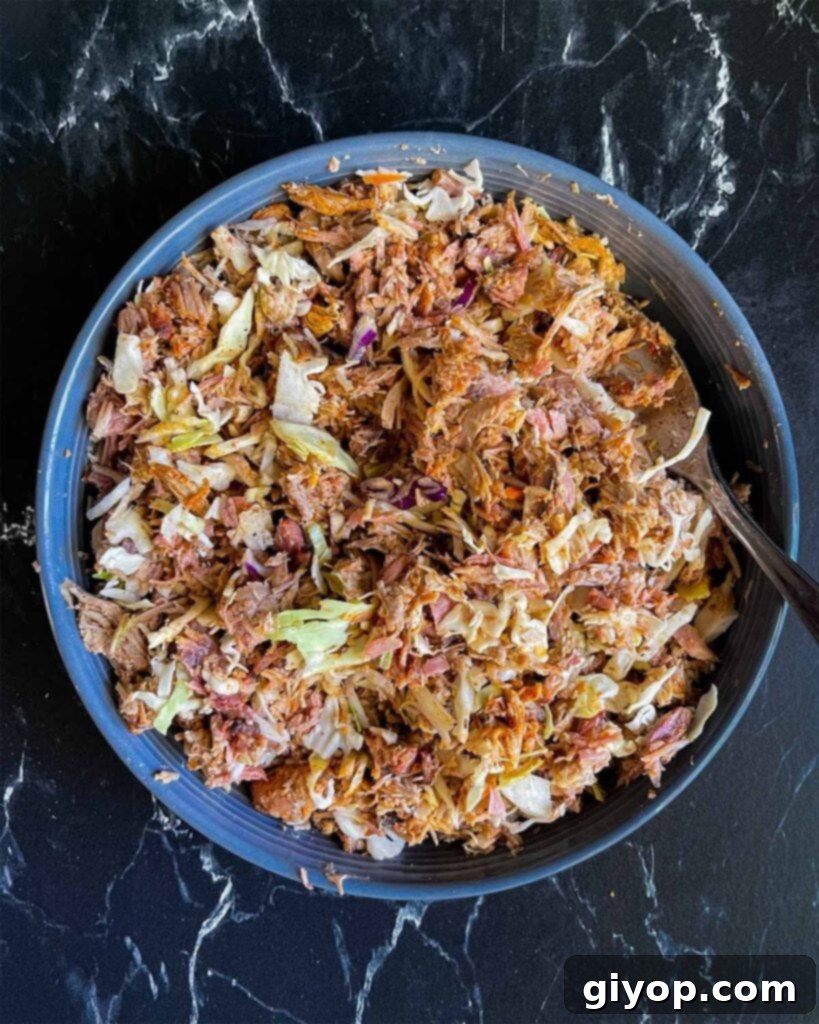 Redneck egg roll mixture in a dark blue bowl.