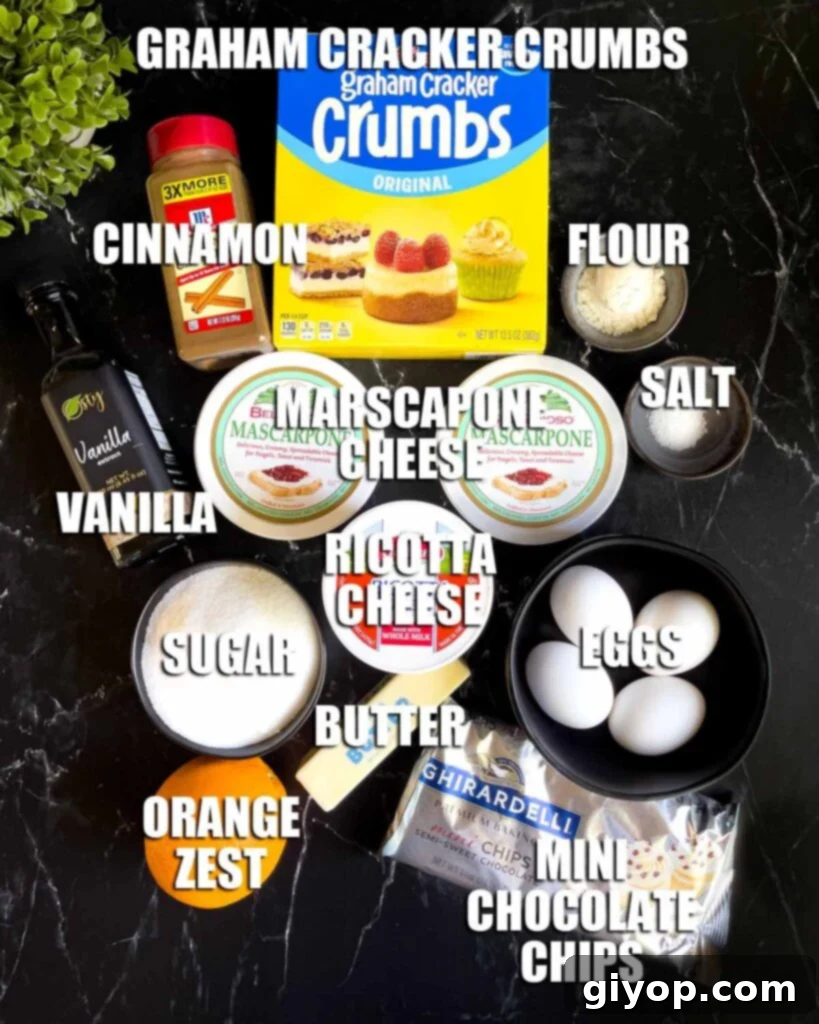 A collection of fresh ingredients for cannoli cheesecake, including ricotta cheese, mascarpone cheese, eggs, graham crackers, chocolate chips, vanilla extract, cinnamon, and an orange, all arranged on a dark background.