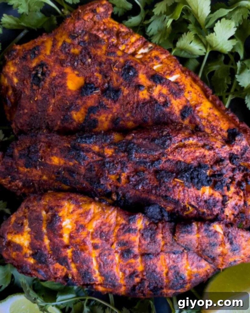 Mexican grilled chicken breast (pachuga asada) on a bed of cilantro.