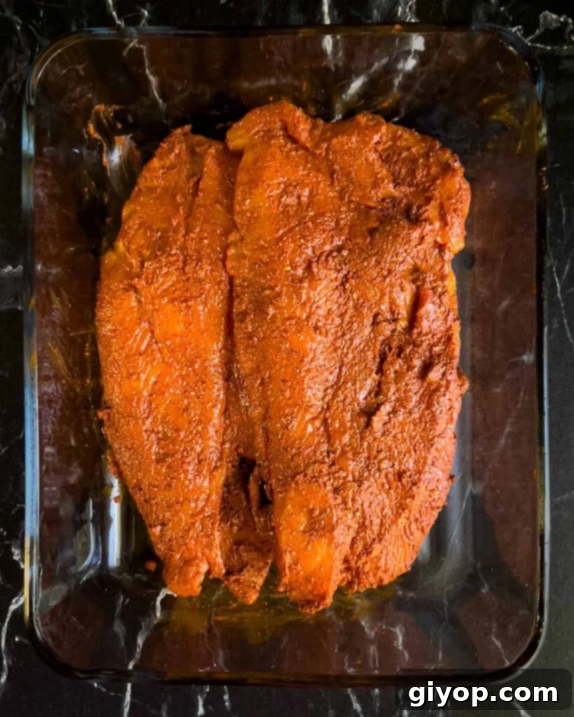 Chicken breasts covered in an annatto based marinade.