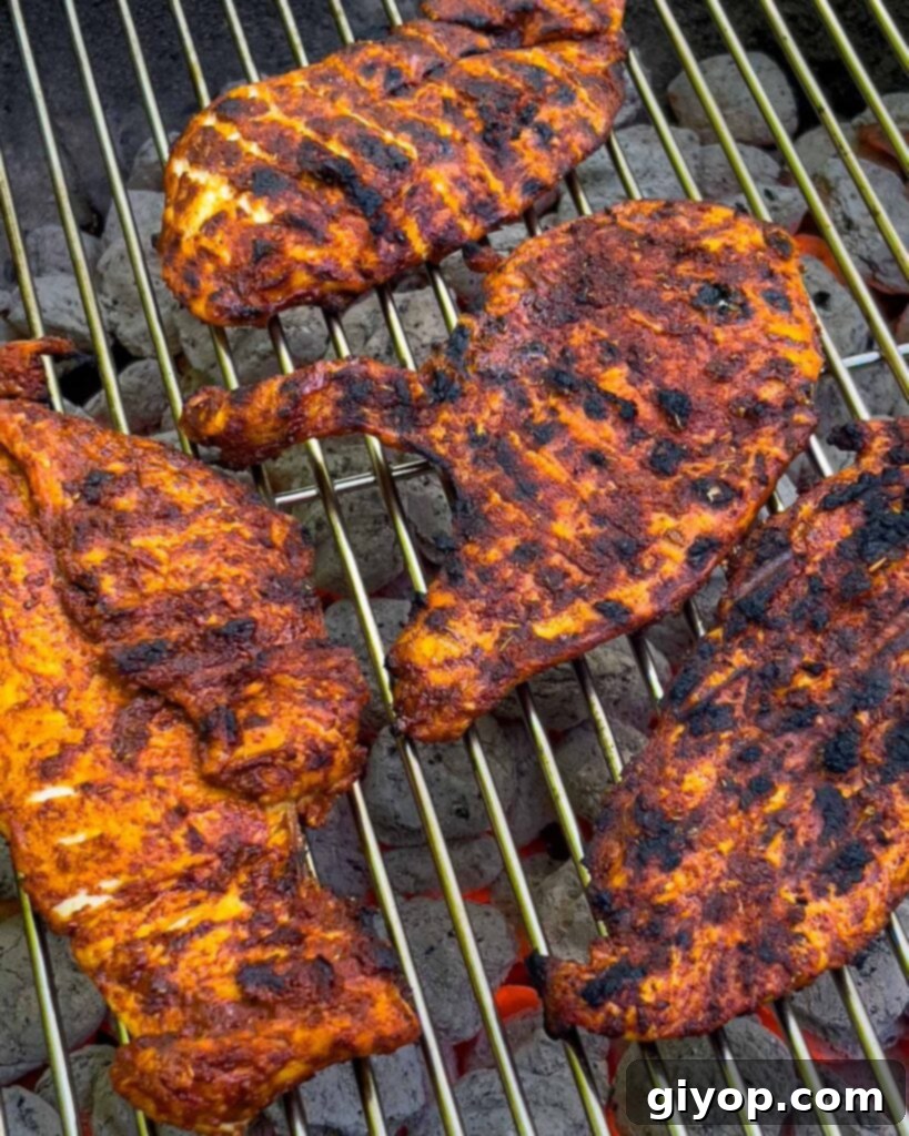 Mexican grilled chicken breast (pechuga asada) on the charcoal grill.