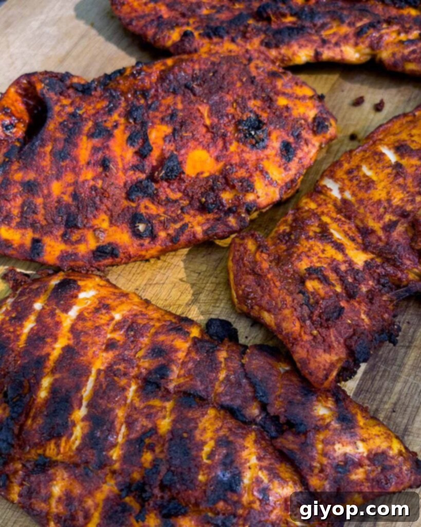 Grilled Mexican chicken breasts right off the grill, resting.