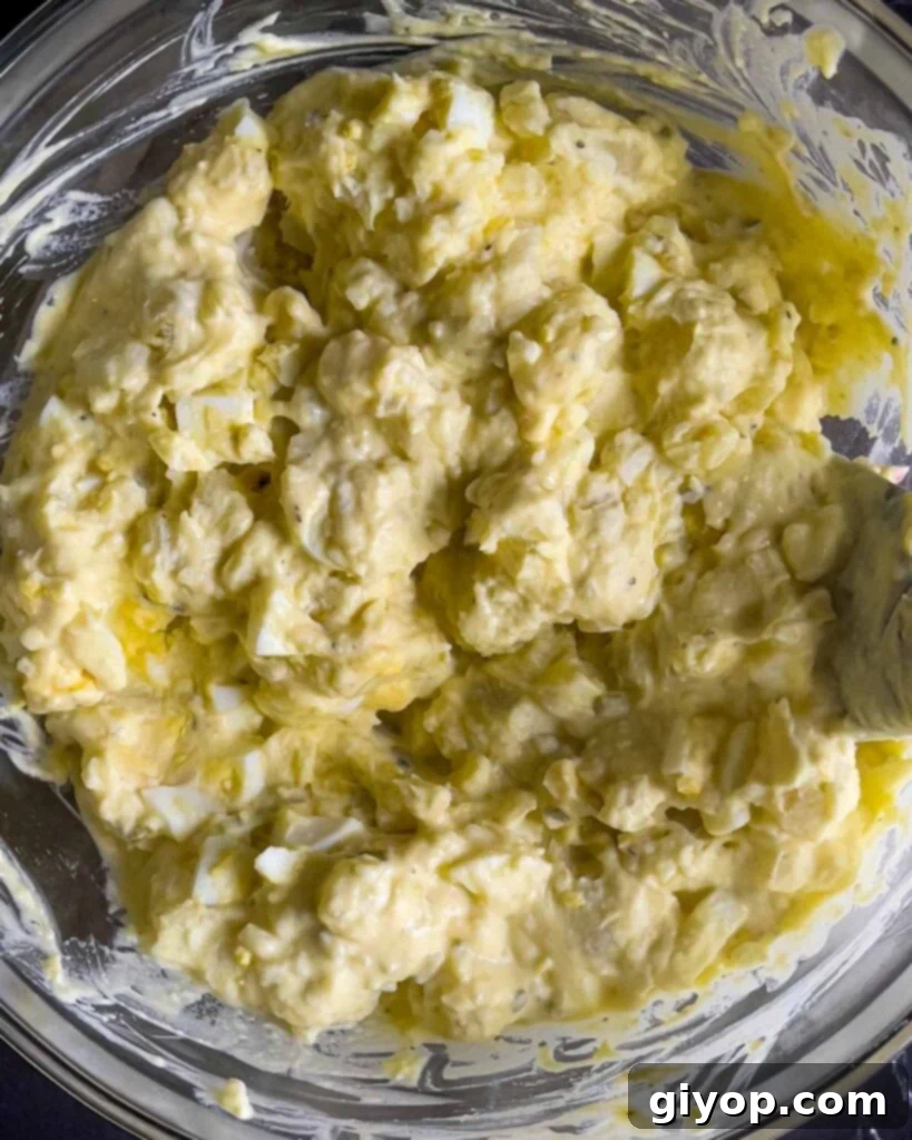 Homestyle Southern Potato Salad 9 Southern potato salad combined in a glass mixing bowl.