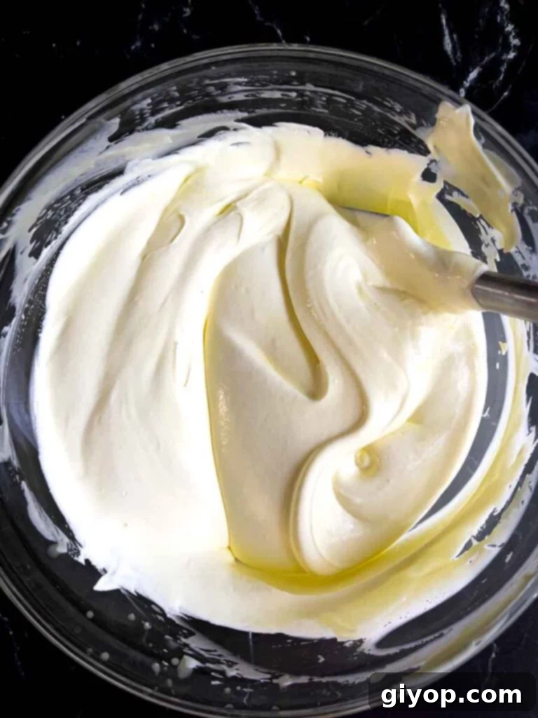 Thick and creamy lemon pudding filling in a glass mixing bowl, ready for layering in the lemon icebox cake.