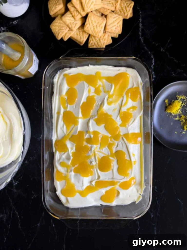 The first layer of the lemon icebox cake, consisting of shortbread cookies, neatly completed in a glass baking dish.
