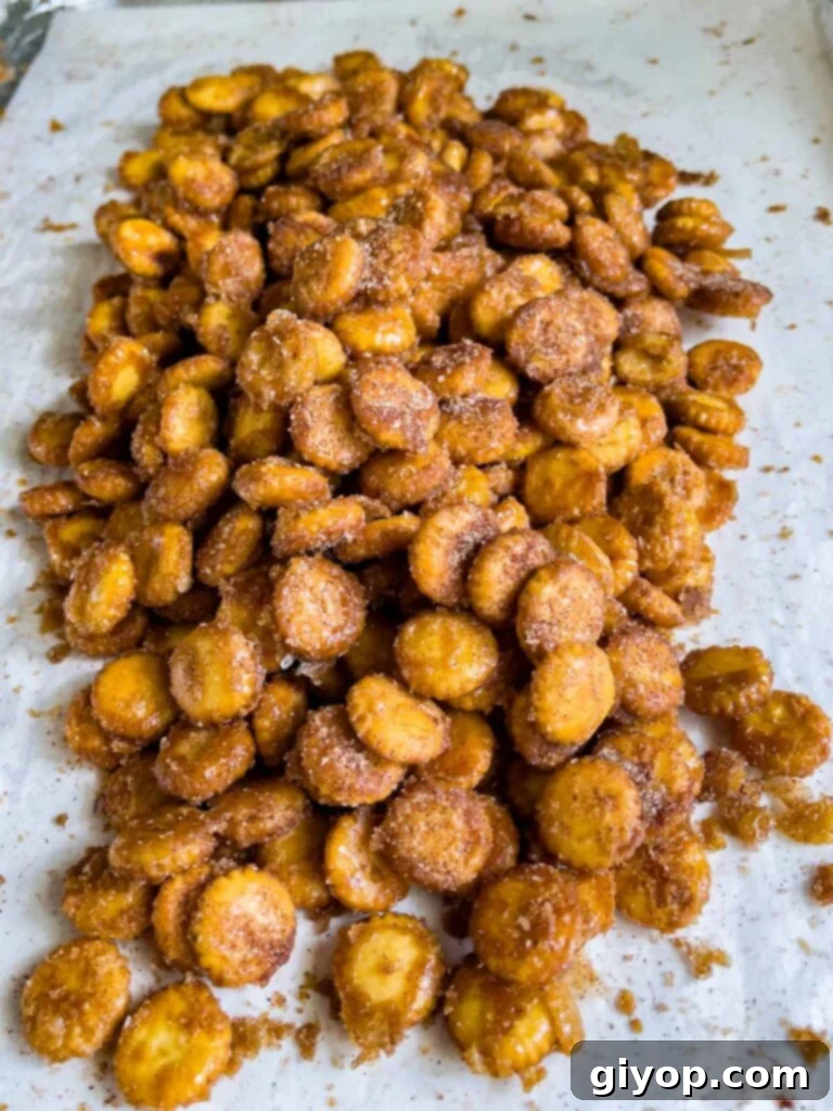 Oyster cracker churro snack mix broken into pieces on a baking sheet.