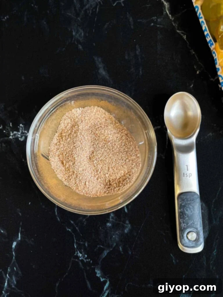 Cinnamon sugar topping mixture for oyster cracker churro snack mix in a glass ramekin.