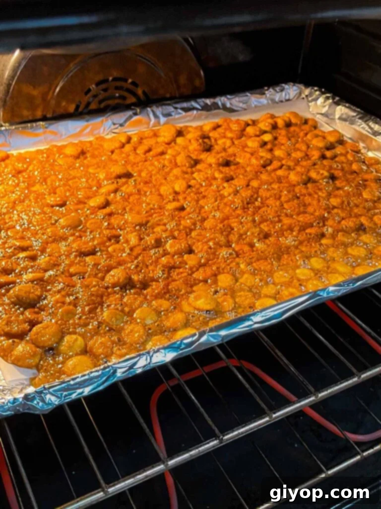 The oyster cracker churro snack mix baking to perfection in the oven.