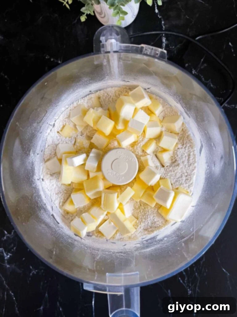 Perfectly Flaky Pie Crust 4 Ingredients for pie crust dough in a food processor before mixing