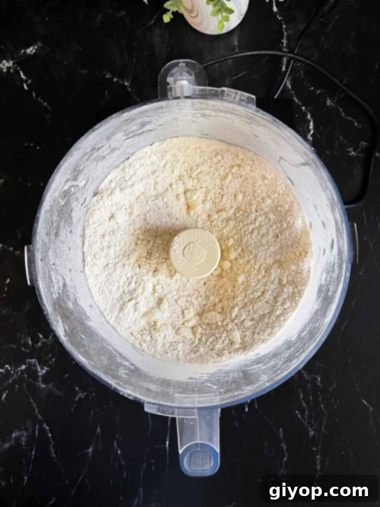 Perfectly Flaky Pie Crust 5 Ingredients for pie crust dough in a food processor, mixed to coarse crumbs.