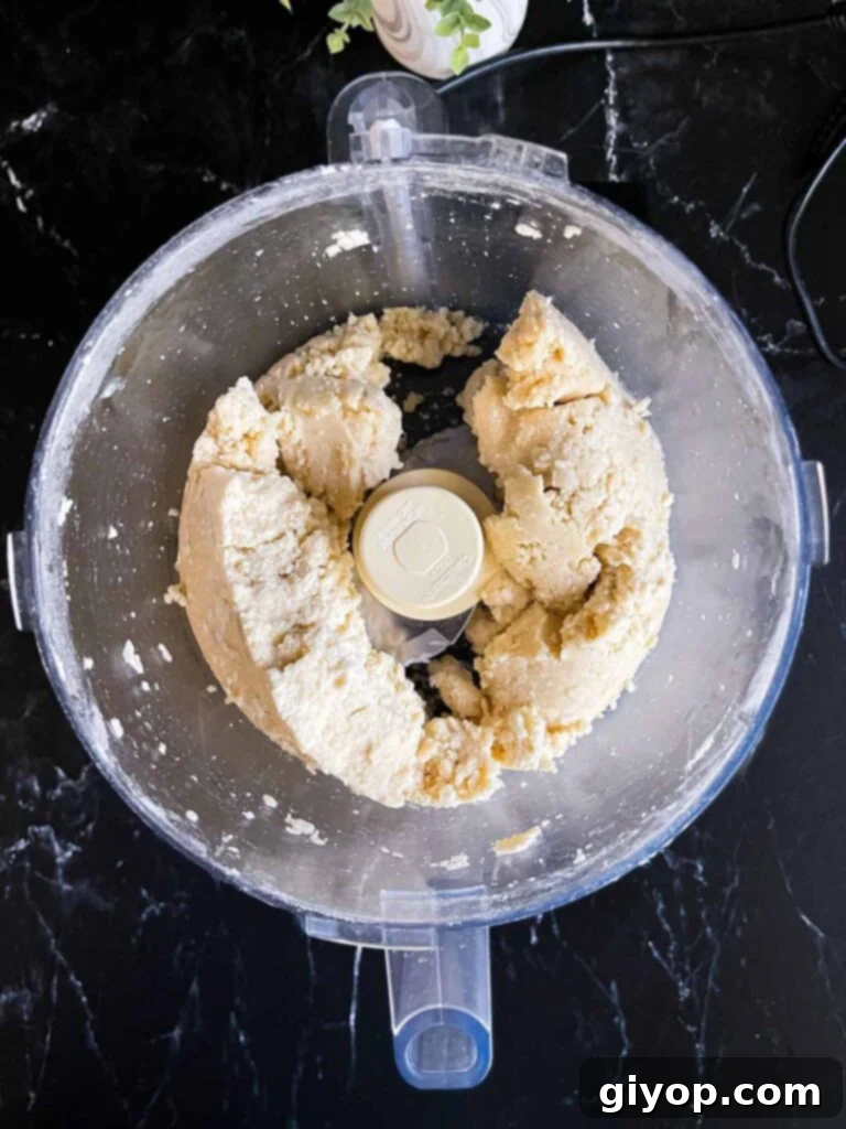 Perfectly Flaky Pie Crust 6 Pie crust dough in a food processor, shaggy consistency.