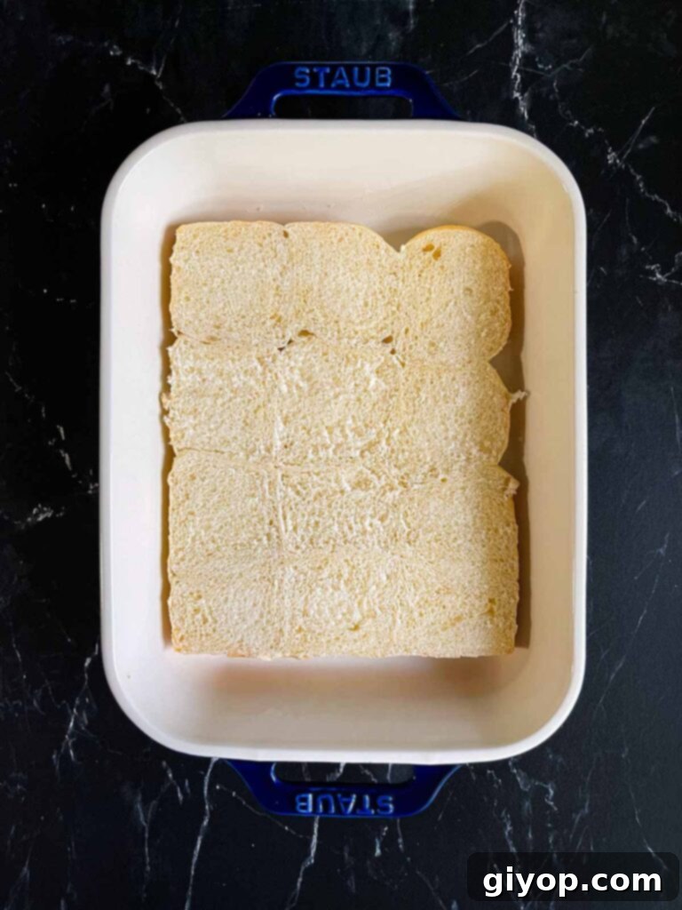 Cheesy Baked Chicken Parmesan Sliders 7 The bottom halves of slider rolls neatly placed in a 9x13 inch baking dish.