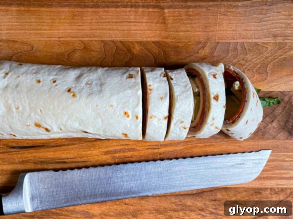 Slicing the italian wrap into pinwheels.