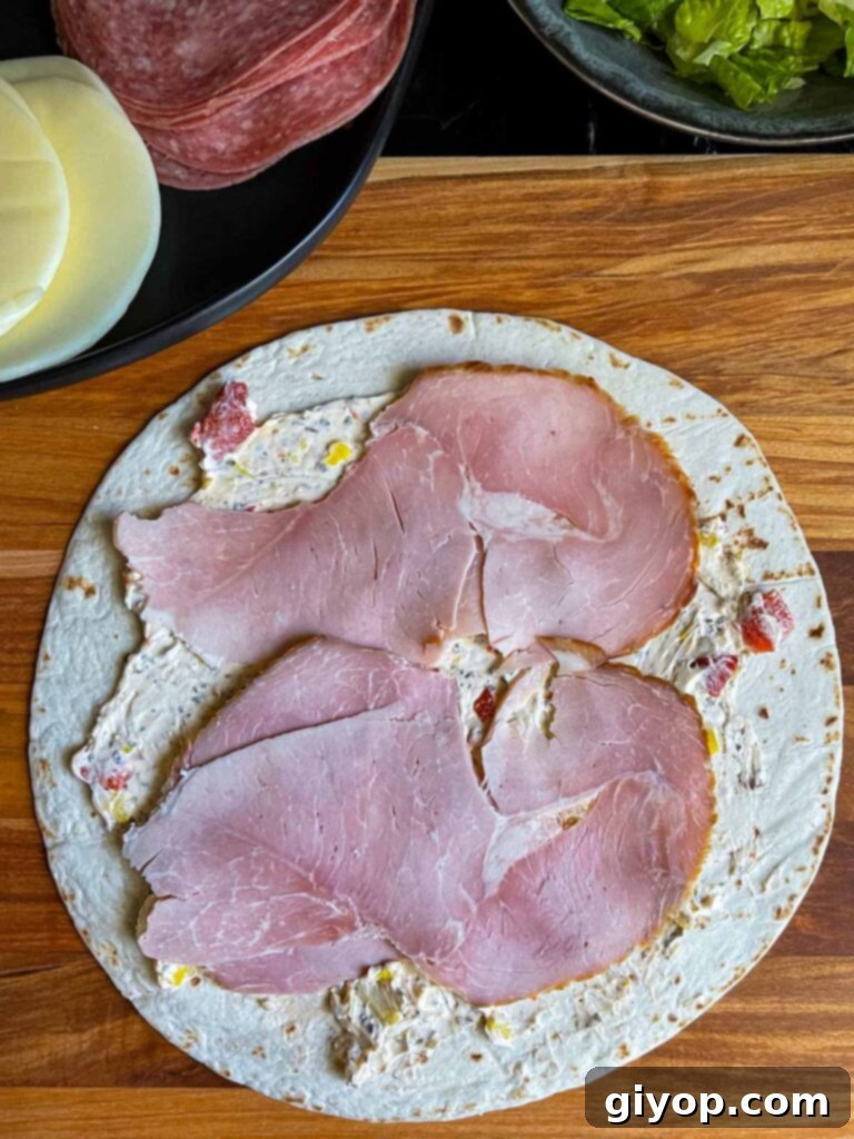 A layer of ham on the italian pinwheel as it's being made.