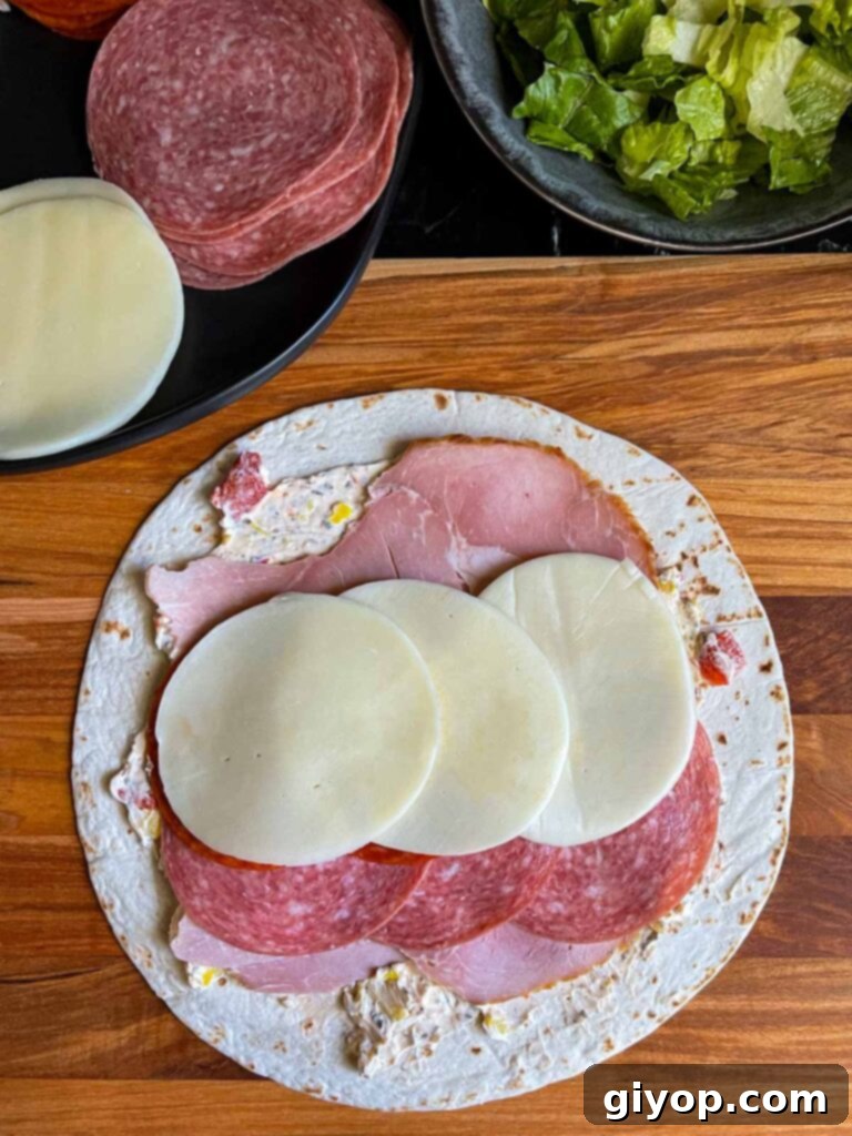 A layer of provolone cheese on the italian pinwheel as it's being made.