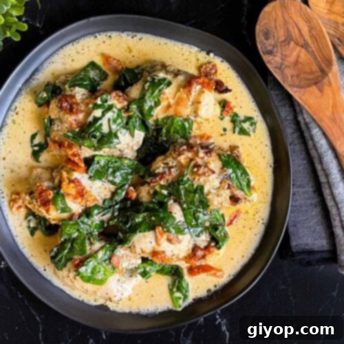 Slow Cooker Tuscan Chicken in a dark bowl on a dark surface.
