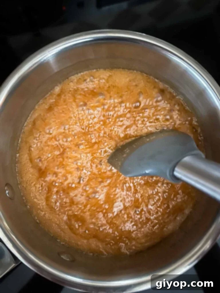 Decadent Pumpkin Bread Pudding with Salted Caramel Drizzle 10 Boiling salted caramel sauce in a saucepan.