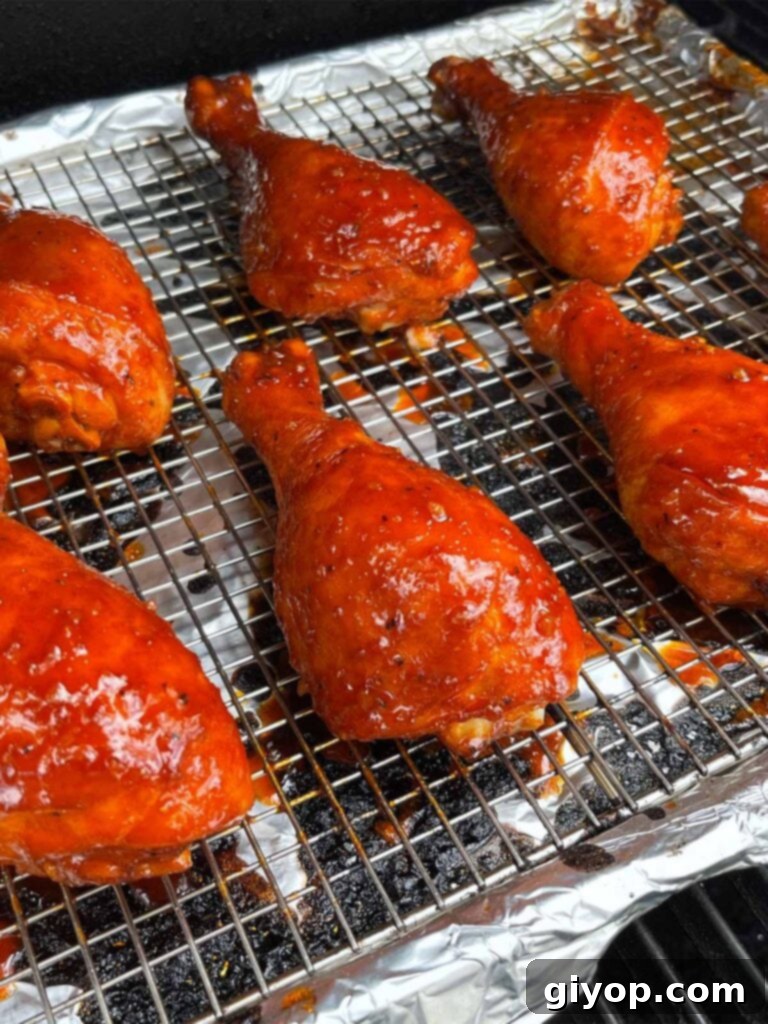Smoky Gochujang Fire Chicken Legs 9 Chicken legs smoking on a smoker.