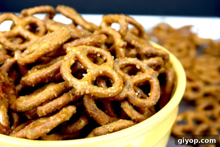 Golden honey mustard pretzels glistening in a vibrant yellow bowl, ready for snacking.