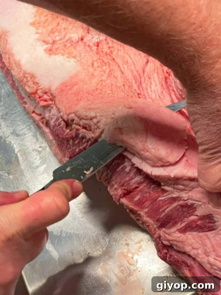 Trimming fat from a brisket.