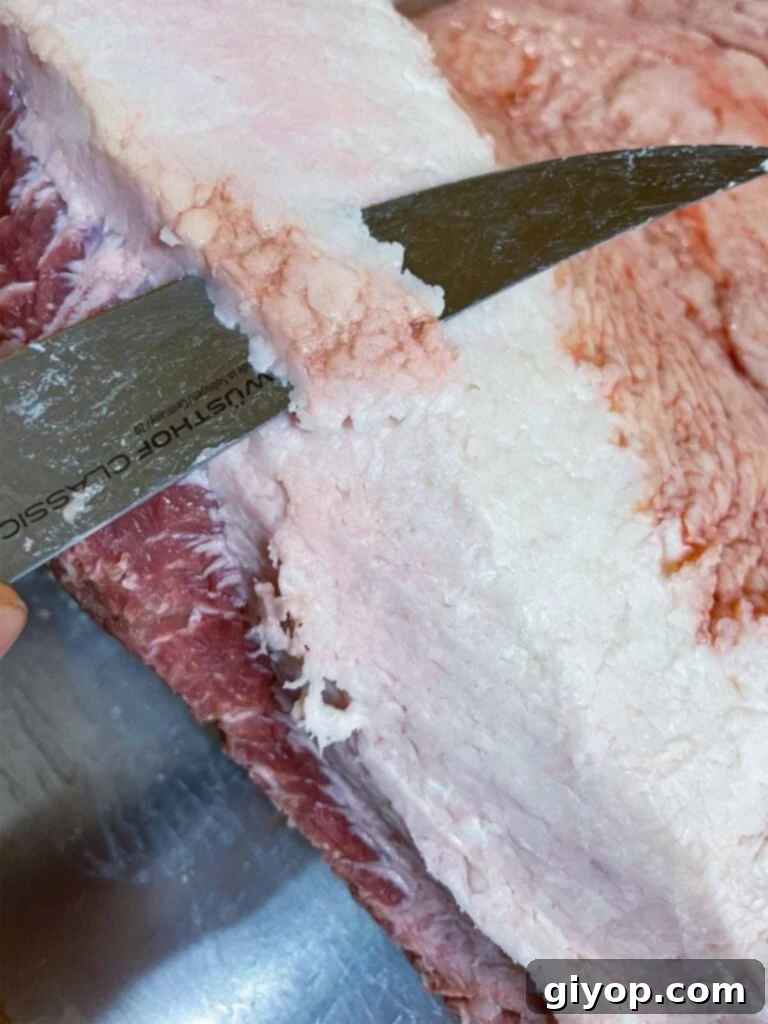Trimming fat from a brisket.