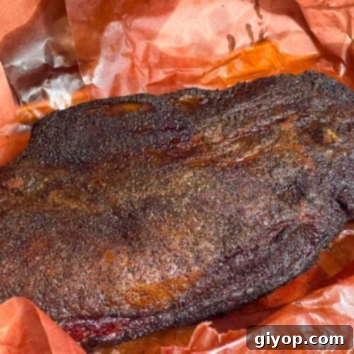 A smoked brisket with the butcher paper unwrapped.