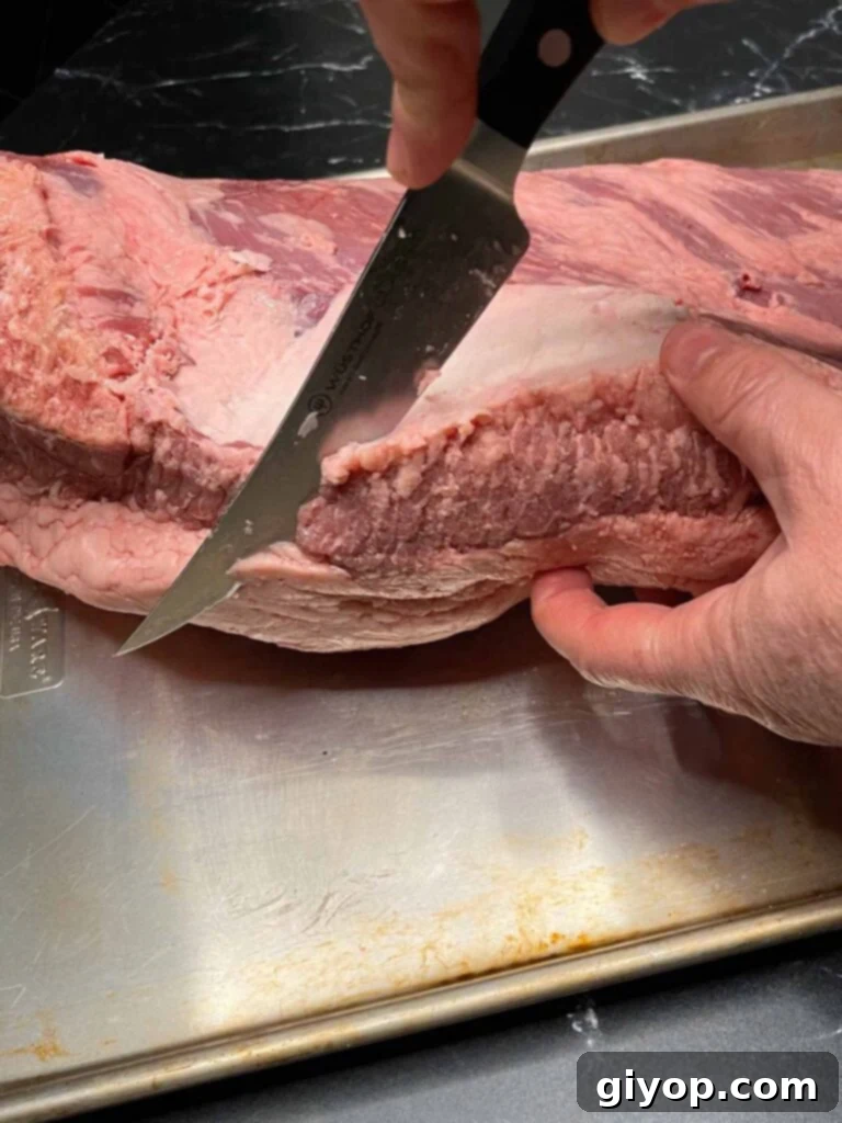 Trimming the edge of a brisket.