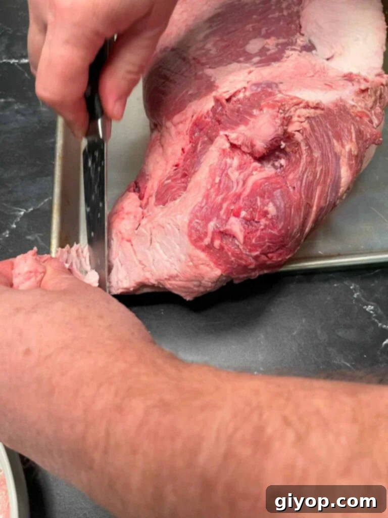 Trimming fat off of a brisket.