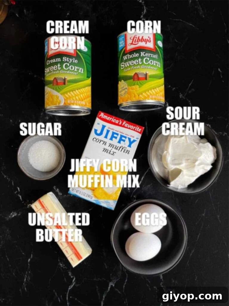 Ingredients needed to make corn casserole on a dark surface.