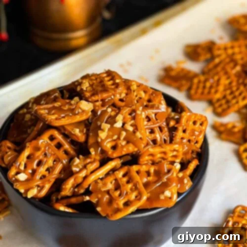 Butter toffee pretzels in a dark bowl on the baking sheet.
