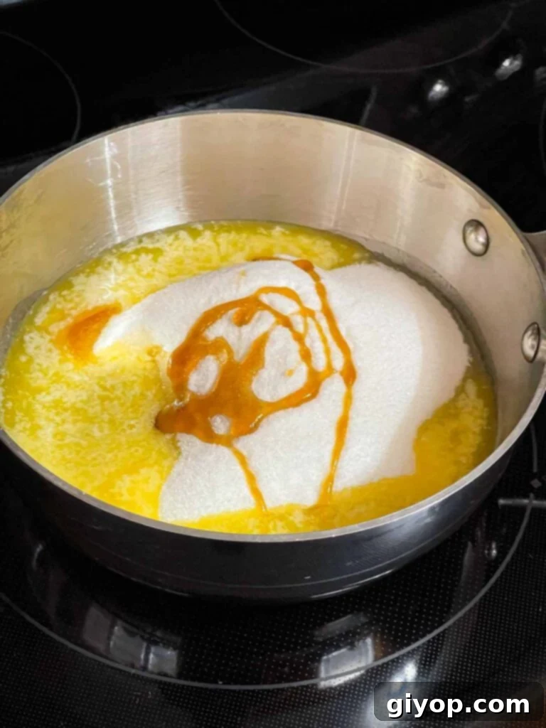 Toffee ingredients in a saucepan on the stove burner.