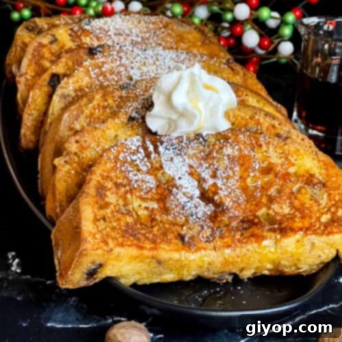Slices of panettone French toast garnished with powdered sugar, whipped cream, and maple syrup on a dark plate, a close-up.