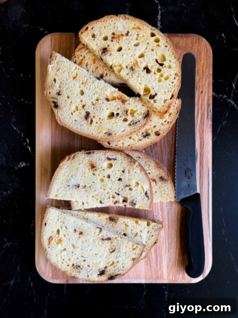 Panettone sliced into half moon slices on a wooden board, ready for the custard dip.