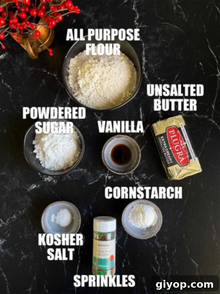 Essential ingredients for whipped shortbread cookies laid out on a dark surface, ready for baking.