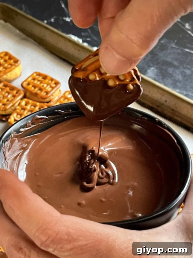 Salty Sweet Peanut Butter Pretzel Treats 7 Peanut butter pretzel bite dipped into melted chocolate.