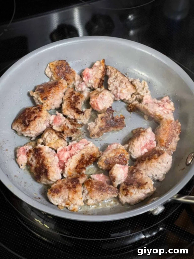 Browned sausage in a small skillet.