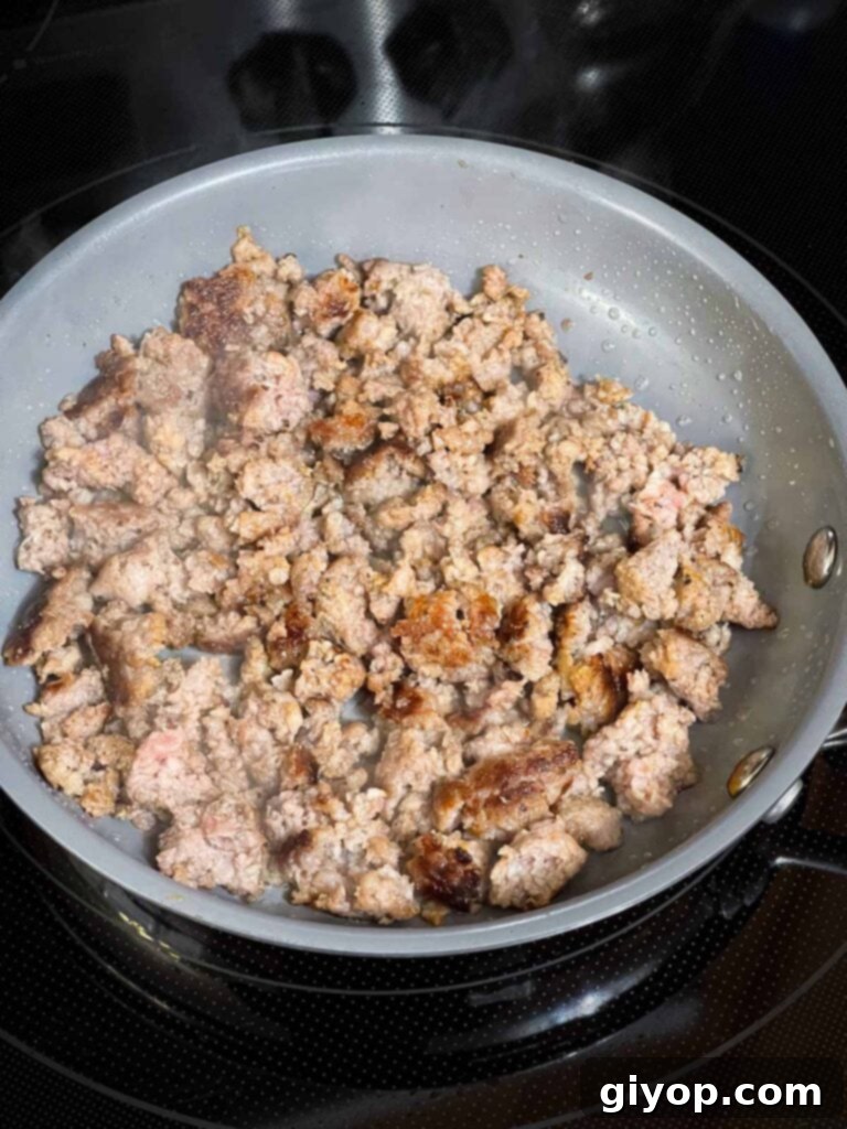 Browned sausage in a small skillet.