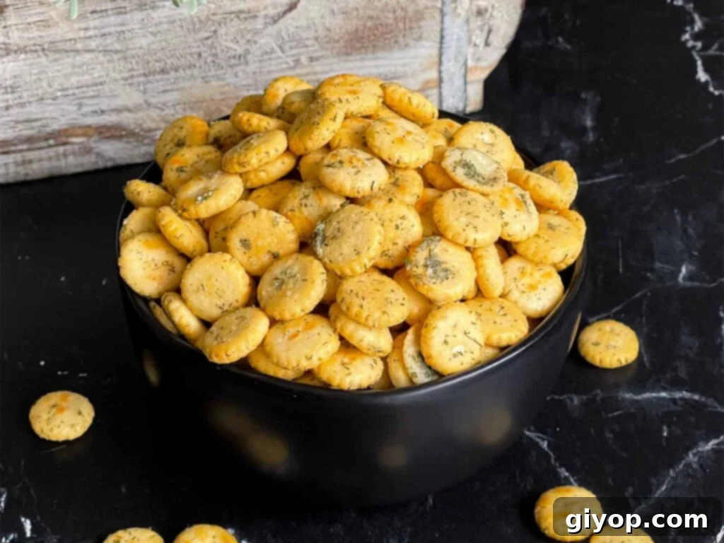Savory Dill Oyster Crackers 2 Dill oyster crackers in a dark bowl on a dark surface, highlighting their rich seasoning.