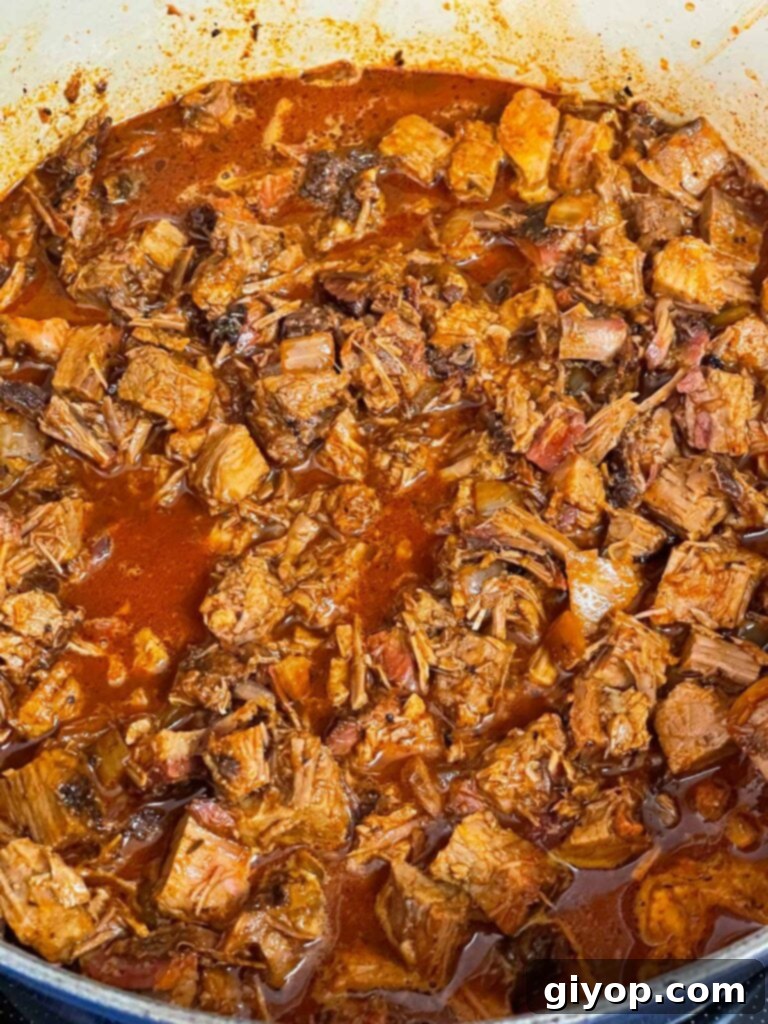 Brisket chili cooking in a dutch oven.