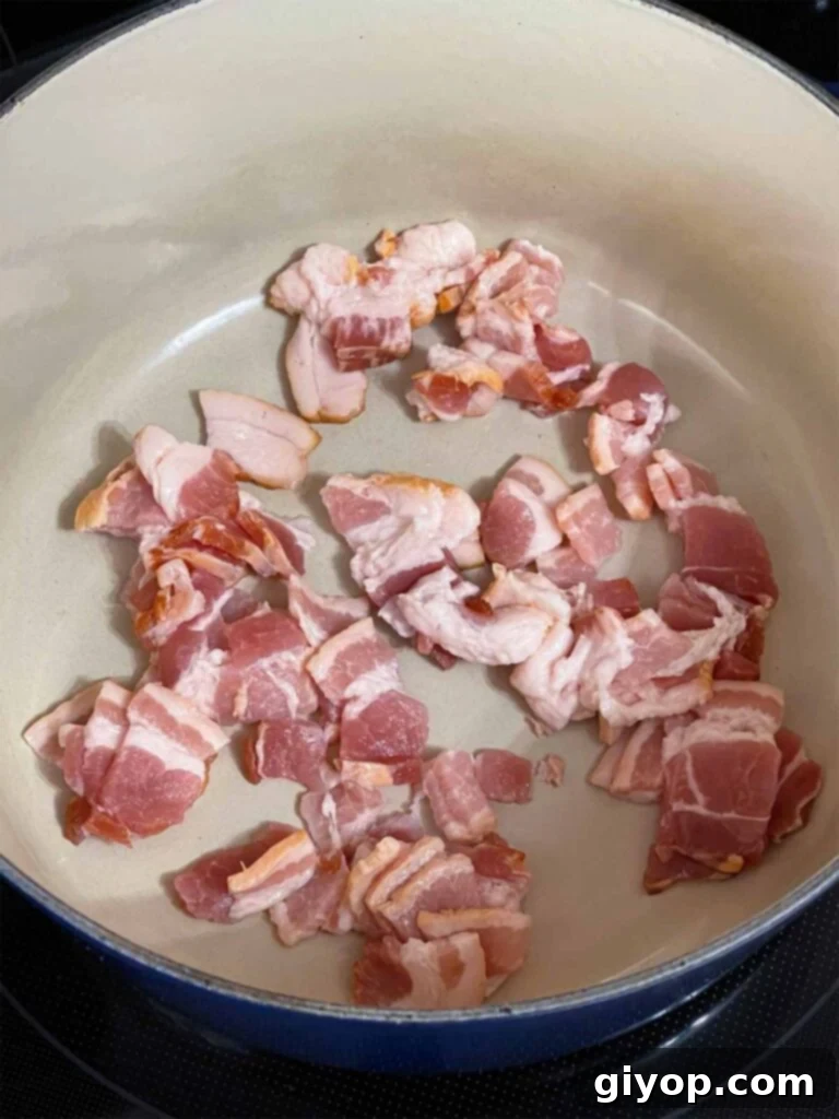 Uncooked chopped bacon in a dutch oven.