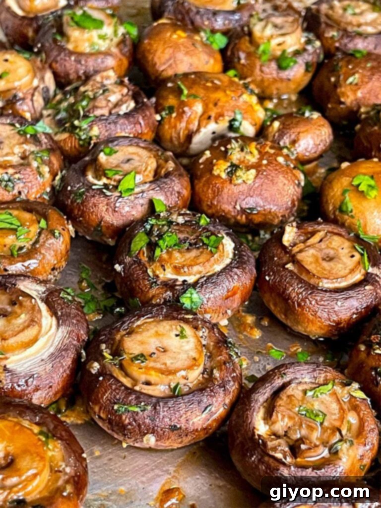 Garlic butter roasted mushrooms on a baking sheet.
