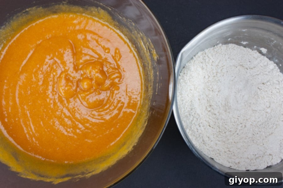 Separate bowls displaying the carefully measured wet ingredients (pumpkin, oil, eggs, sugar) and dry ingredients (flour, spices, leavening) for bakery-style pumpkin muffins.