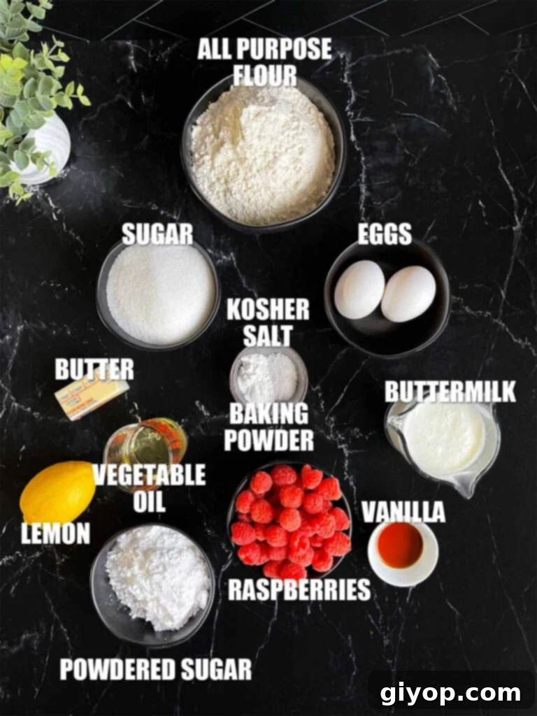 All the fresh ingredients for homemade raspberry muffins, including flour, sugar, eggs, butter, buttermilk, vanilla, and vibrant raspberries, arranged neatly on a dark surface.