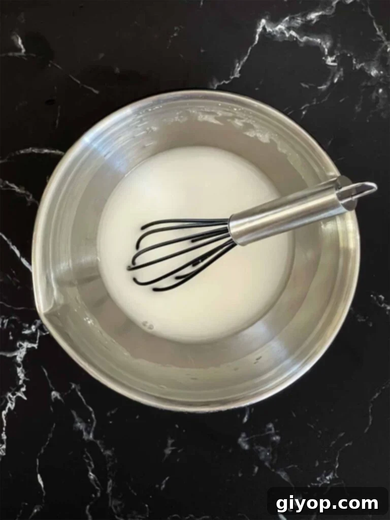 A cornstarch slurry in a small mixing bowl.