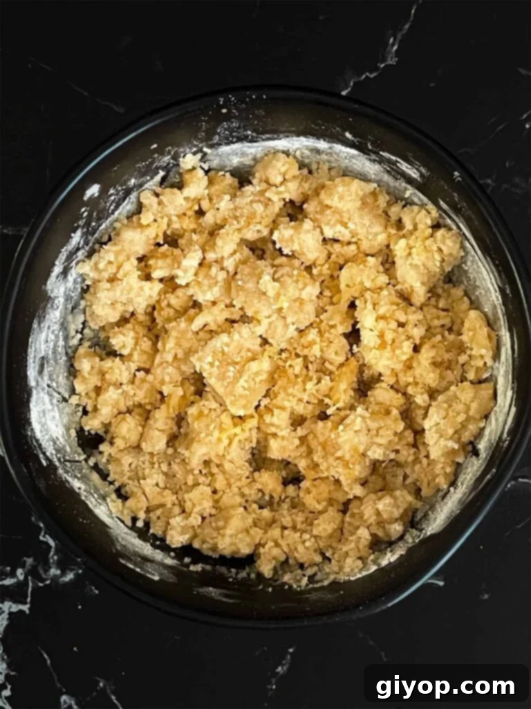 Lemon crumb cake crumble ingredients mixed in a dark bowl.