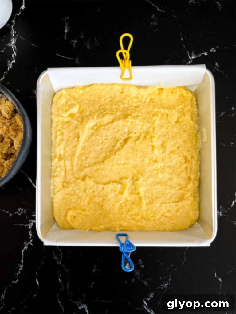 Lemon crumb cake batter in a prepared baking pan.