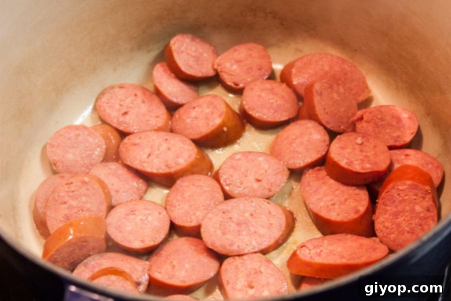 Louisiana Surf and Turf Gumbo 4 Andouille sausage browning in a Dutch oven, creating a flavorful base for the gumbo.