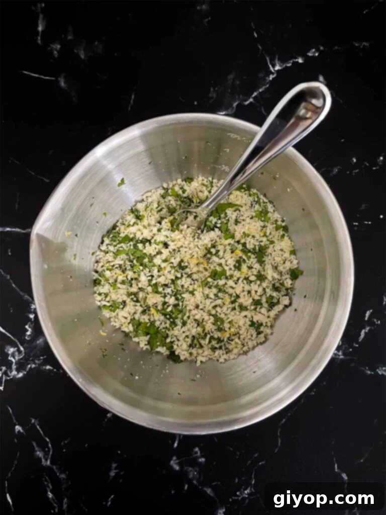A large mixing bowl containing the perfectly seasoned ground chicken meatball mixture, ready for shaping.