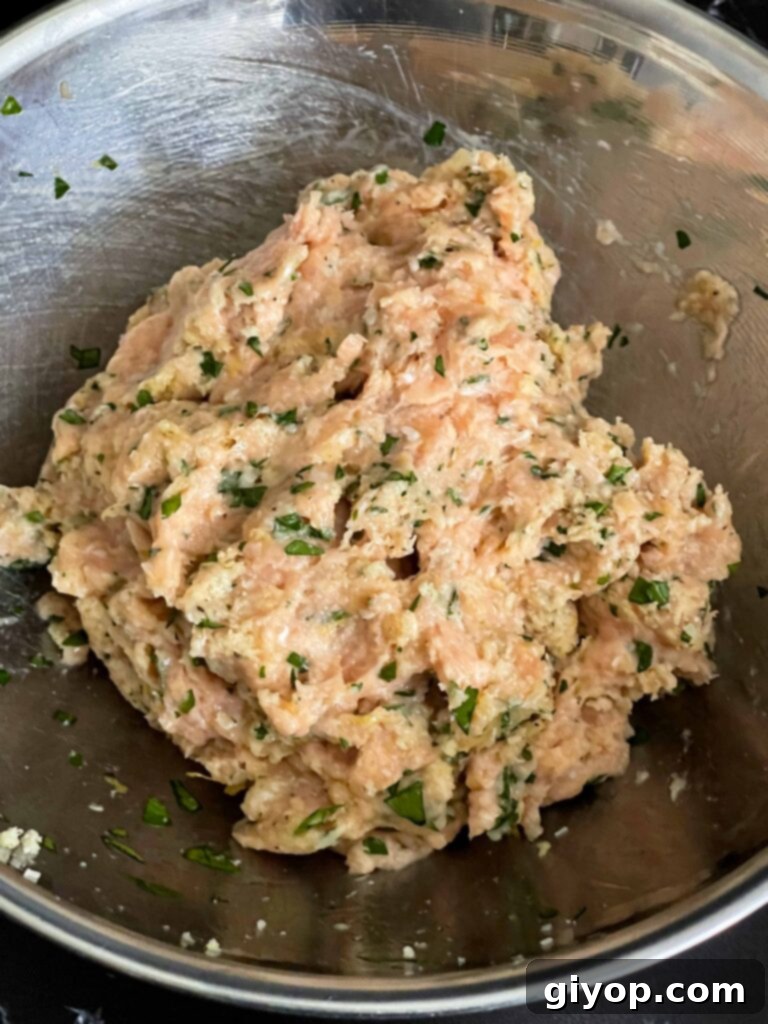 The well-combined chicken piccata meatball mixture in a bowl, ready to be shaped.