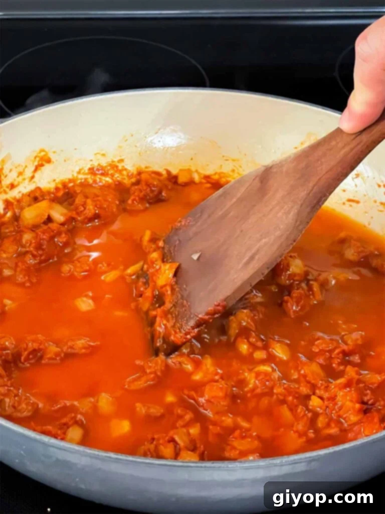 Vodka sauce simmering and reducing in a skillet.